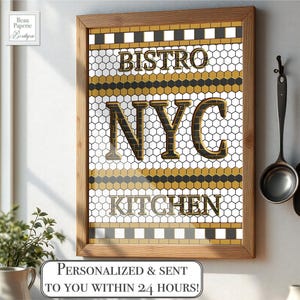May include: Framed wall art with "BISTRO NYC KITCHEN" text in gold and black. The background features a honeycomb pattern with gold, black, and white accents. The wooden frame surrounds the artwork. The text "PERSONALIZED & SENT TO YOU WITHIN 24 HOURS!" is at the bottom.