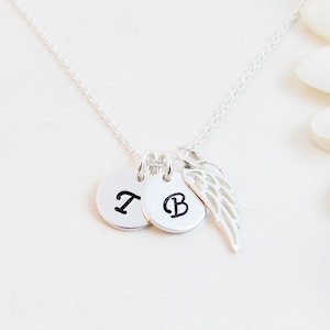 Sterling Silver Remembrance Angel Wing Necklace: a thoughtful bereavement gift for a grieving friend or family member.  Created with two initial charms and a wing charm on a silver chain. All components are sterling silver