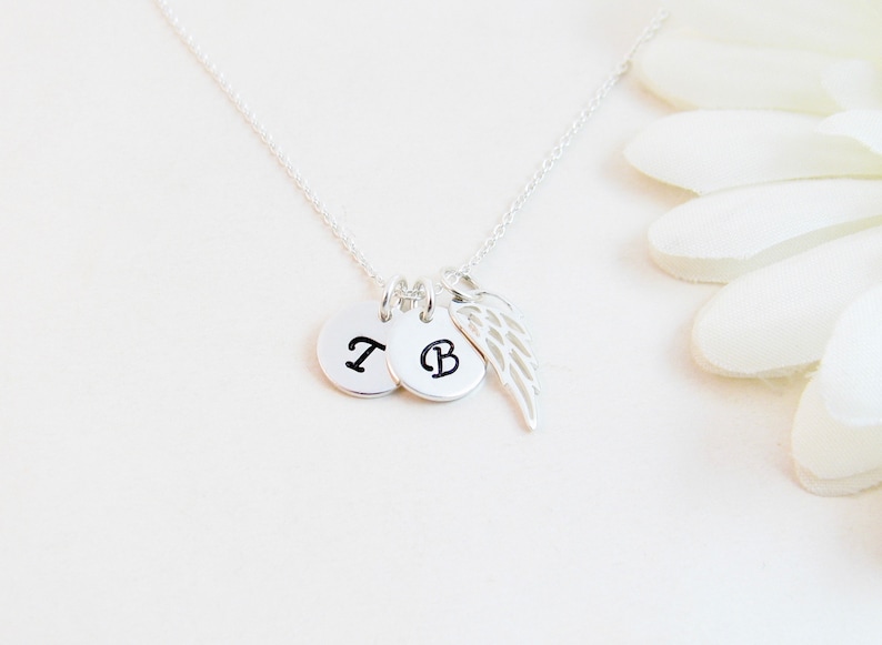 Sterling Silver Remembrance Angel Wing Necklace: a thoughtful bereavement gift for a grieving friend or family member.  Created with two initial charms and a wing charm on a silver chain. All components are sterling silver