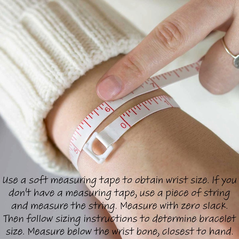 May include: A white measuring tape is wrapped around a wrist to measure its circumference. The tape reads 6 inches. Text on the image advises using a measuring tape or string to determine bracelet size. Measure below the wrist bone, closest to hand.