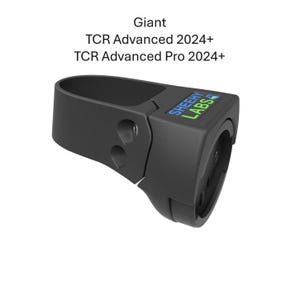 May include: A black bicycle component with the text "SHEEHY LABS" in blue and green. The component is designed to fit a Giant TCR Advanced 2024+ and TCR Advanced Pro 2024+ bicycle. The component has a curved design with two holes.