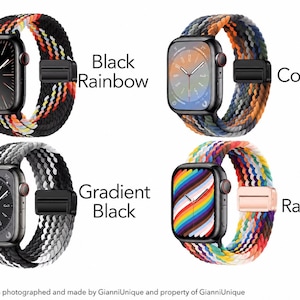 May include: Four smartwatches with braided bands in different color patterns. Top left: Black Rainbow. Top right: Cowboy with earth tones. Bottom left: Gradient Black with gray and white. Bottom right: Rainbow with a multi-colored watch face.