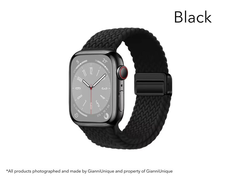 May include: A black smartwatch with a rectangular screen displaying a clock face with white hands and a red second hand. The watch features a textured, braided black band with a matching black magnetic clasp. The word Black is printed above.
