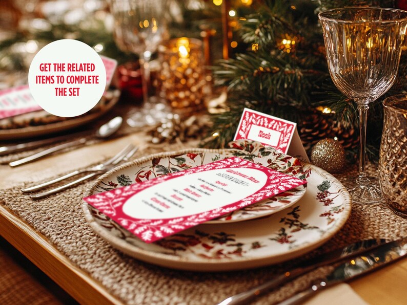 May include: A red and white Christmas menu card with a floral design sits on a white plate with a floral pattern. The plate is on a brown woven placemat. A glass of water and a gold candle holder are in the background. The text on the card reads "Christmas Menu".