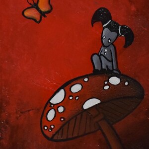 May include: A whimsical painting featuring a stylized figure seated atop a red mushroom with white spots. An orange butterfly hovers nearby against a red background. The artwork has a cartoonish style.