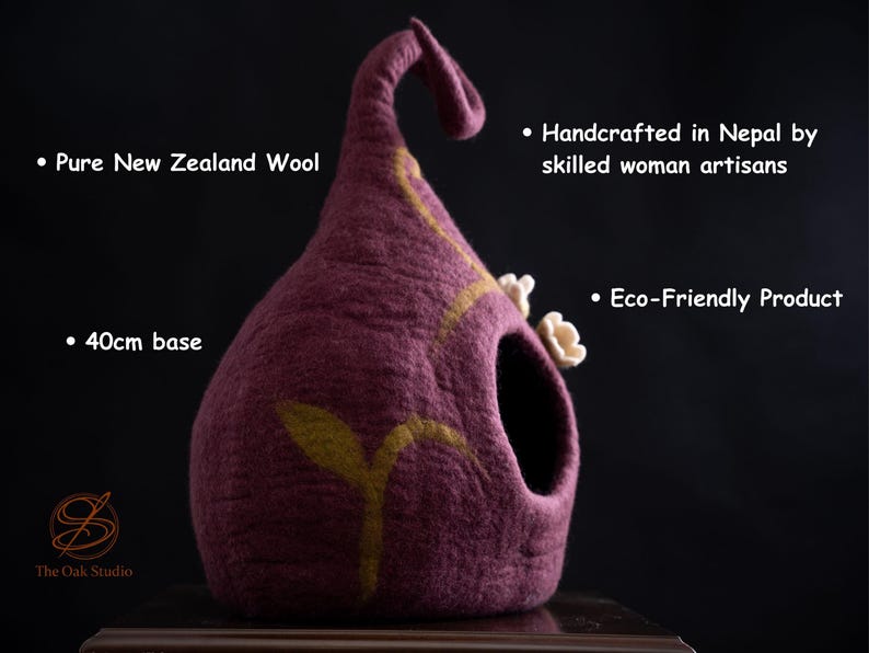 May include: A handcrafted, eco-friendly pet bed made from pure New Zealand wool. The plum-colored bed has a 40cm base, a curved top, and a decorative yellow leaf design. It is handmade in Nepal.