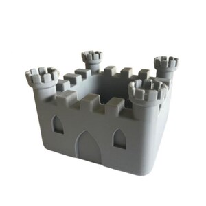 May include: A grey plastic castle-shaped trinket box with four towers. The box has a square base and a small opening in the centre.
