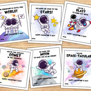 May include: Six printable Valentine's Day cards featuring astronaut illustrations with space-themed puns. The cards have a watercolor background with planets and stars.