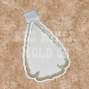 May include: White plastic cookie cutter shaped like a Christmas tree. The cutter has a star at the top and a wavy edge.