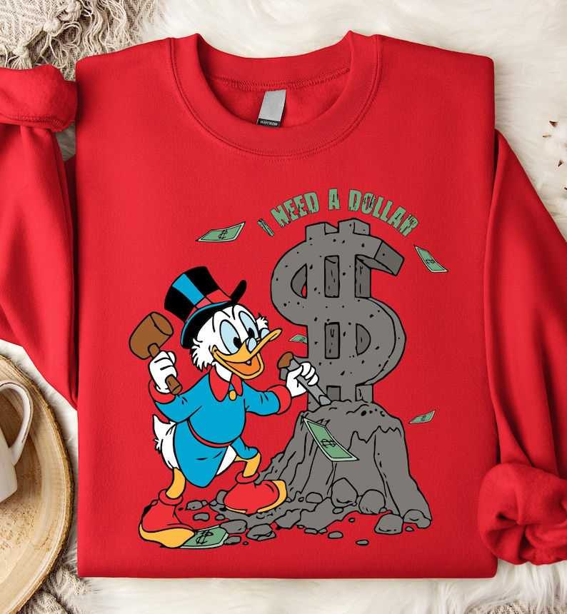 Hilarious Scrooge McDuck money tee for men and women who love cash, wealth, and success. This retro cartoon shirt features the famous duck diving into gold coins, making it a perfect gift for investors, finance lovers, and classic Disney fans!