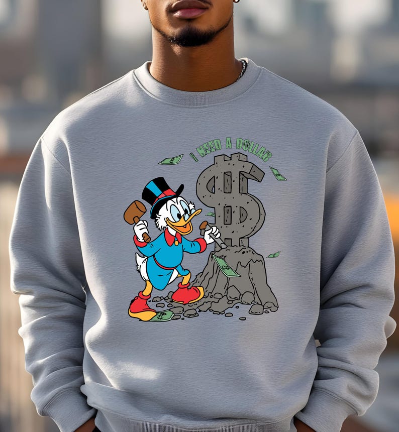 Hilarious Scrooge McDuck money tee for men and women who love cash, wealth, and success. This retro cartoon shirt features the famous duck diving into gold coins, making it a perfect gift for investors, finance lovers, and classic Disney fans!