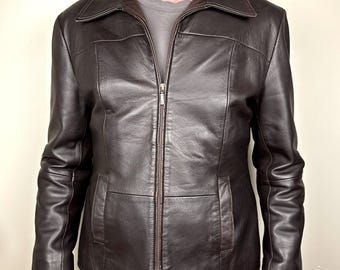 May include: A brown leather jacket with a zipper closure and a stand-up collar.