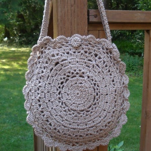 A crochet pattern from Nancy Brown-Designer - a pattern for a doily inspired round bag. Inspired by a simple to crochet doily, this bag is a fashion must-have. Two doilies are crocheted together with a gusset. A strap and button completes the look.