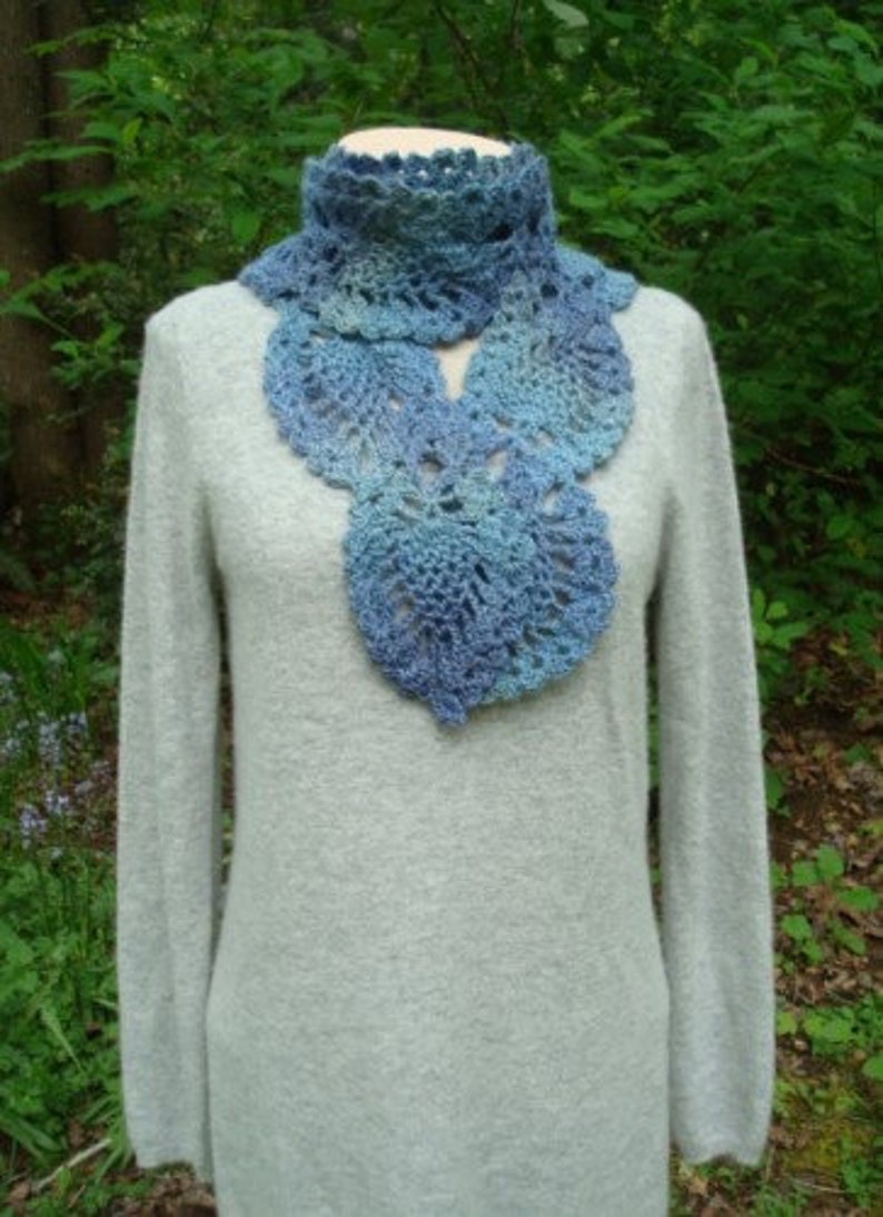 A crochet pattern from Nancy Brown-Designer - a lovely scarf crocheted in a pineapple design. Soft, warm and cuddly pineapples cascading around the neck makes this beautiful scarf a fashion must-have.