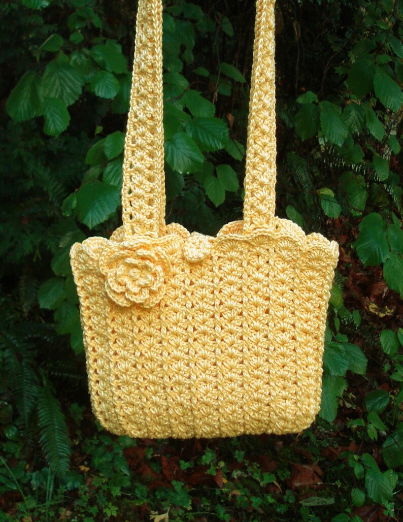 A crochet pattern from Nancy Brown-Designer - a pattern for a lovely cotton bag that is easy to make and easy to wear. A wonderful little cotton bag that is just about perfect for summer days. Embellish with an eye-cathing crocheted flower.