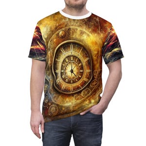 May include: A short-sleeved t-shirt featuring a detailed, golden clock design with Roman numerals and intricate details. The shirt has a white crew neck and a vibrant, swirling background with shades of gold, orange, and red.