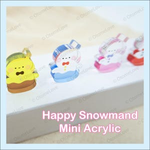 May include: Mini acrylic charms featuring a yellow character, a snowman, and other designs. The charms have a cartoon style and are in various colors. The text "Happy Snowmand Mini Acrylic" is visible in the image.