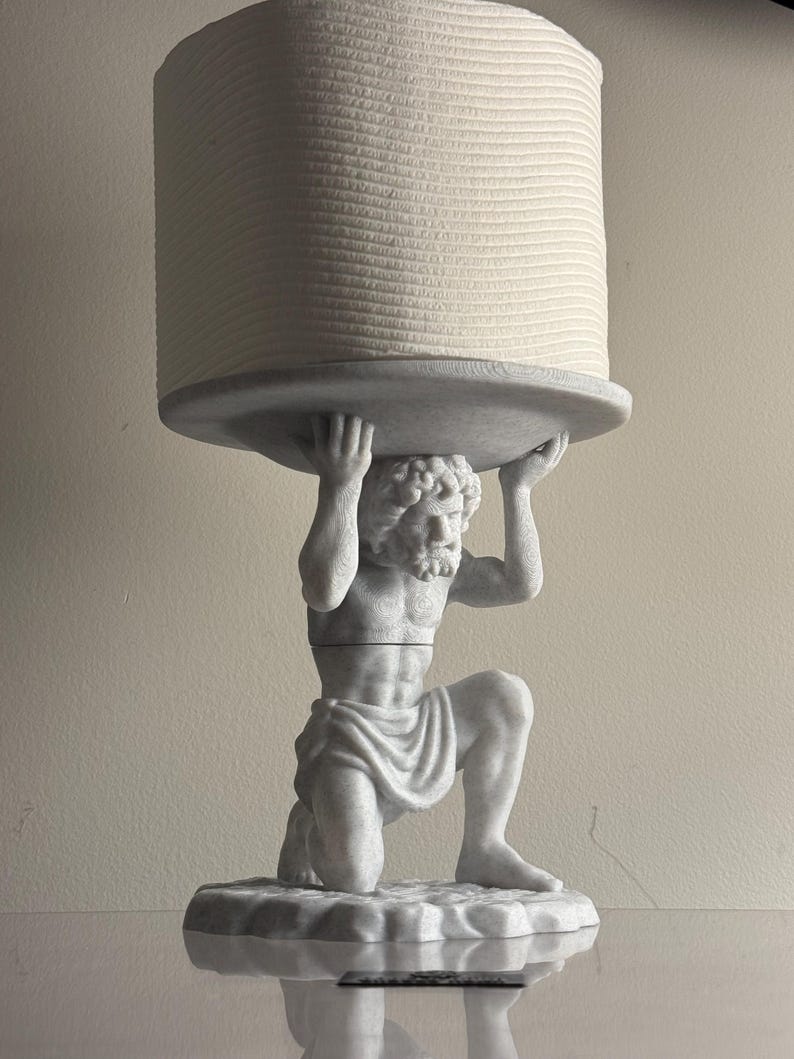 Marble-finish Atlas figure kneeling to hold a paper roll above his shoulders