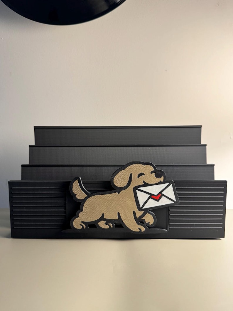 Black slotted mail organizer with a golden retriever carrying an envelope, holding letters