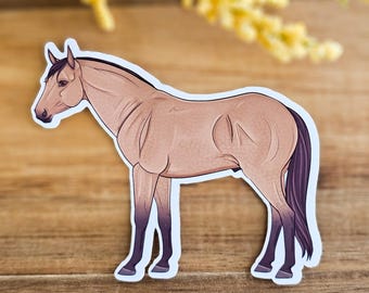 May include: A tan horse with a black mane and tail stands on a wooden surface. The horse is facing to the left and has a light brown coat.