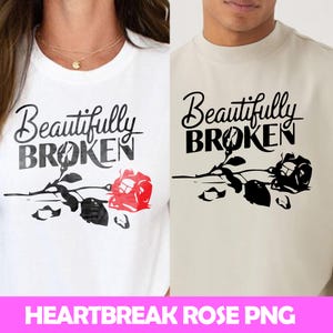 May include: Two white t-shirts with black text that reads "Beautifully Broken" and a black silhouette of a broken rose. One shirt has a red rose.