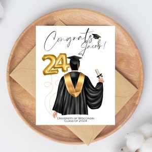 May include: A graduation card with the words "Congrats Jacob!" and a gold foil balloon that reads "24". The illustration shows a graduate in a black gown and gold stole, holding a diploma. The card also includes "UNIVERSITY OF WISCONSIN CLASS OF 2024".