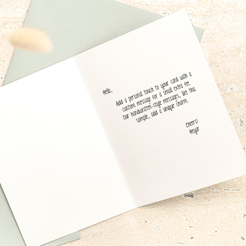 Puede incluir: Una tarjeta blanca con un mensaje escrito a mano en el interior. El mensaje dice "Hola, Agrega un toque personal a tu tarjeta con un mensaje personalizado por una peque&ntilde;a tarifa adicional. Nuestros mensajes de estilo manuscrito, como este ejemplo, a&ntilde;aden un encanto &uacute;nico. &iexcl;Saludos! Heyor"