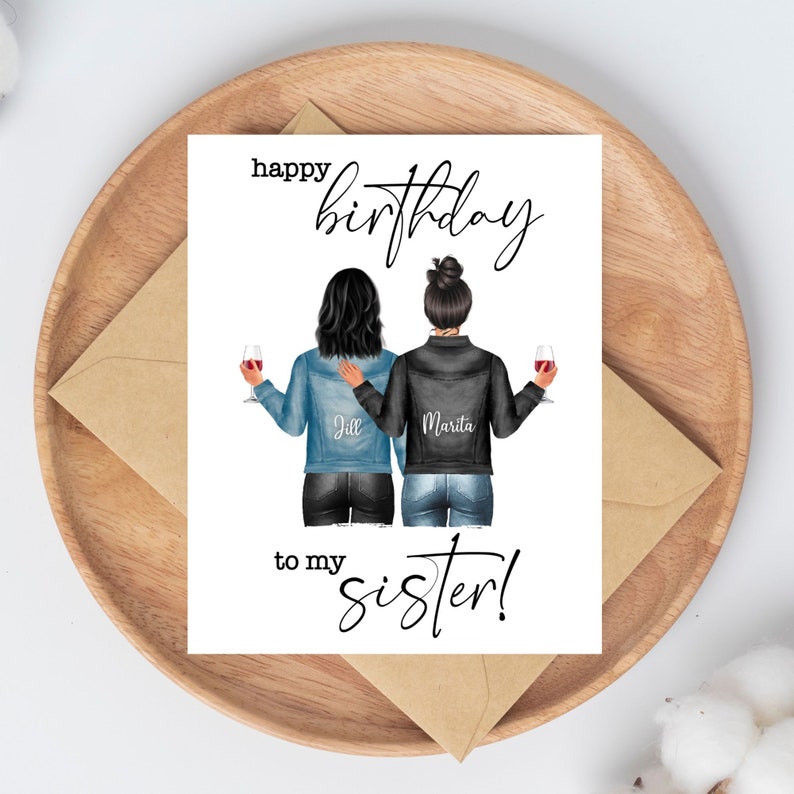 May include: A greeting card with the text "Happy Birthday to my sister!" features an illustration of two women in denim and black jackets, holding wine glasses. The card is on a wooden tray with an envelope.