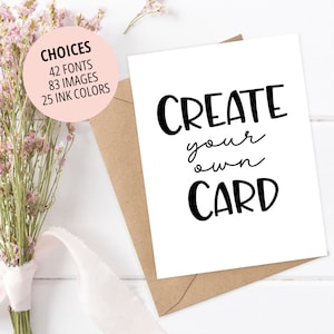 May include: White card with black text that reads "CREATE your own CARD". The card is sitting on a brown envelope. A bouquet of pink flowers is in the background.