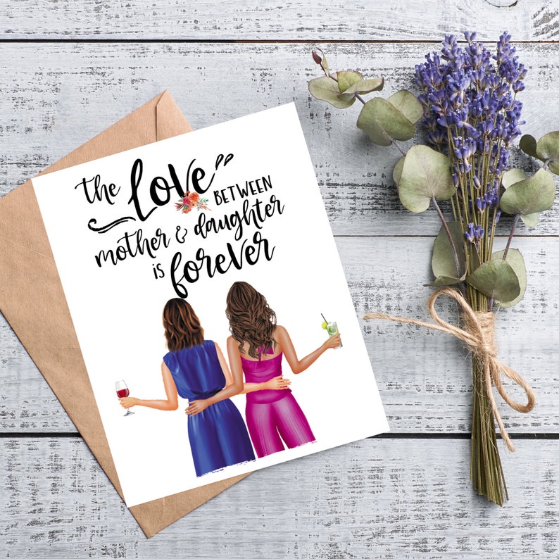 May include: A greeting card with the text "the love between mother & daughter is forever" and an illustration of two women. The card is accompanied by a brown envelope, a bouquet of lavender, and eucalyptus leaves.