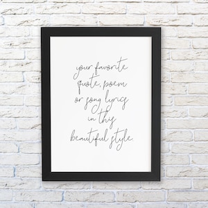 May include: Black framed print with white background and black cursive text that reads "your favorite quote, poem or song lyrics in this beautiful style."