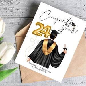 May include: A graduation card with a drawing of a graduate in a black gown and gold stole, holding a diploma. Gold foil balloons shaped as the number 24 are on the left. The card reads "Congrats Jacob!" and "University of Wisconsin Class of 2024."
