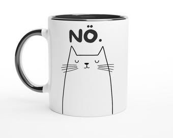 May include: White ceramic mug with a black rim and handle. The mug has a black and white illustration of a cat with the word "Nö." printed on the front.