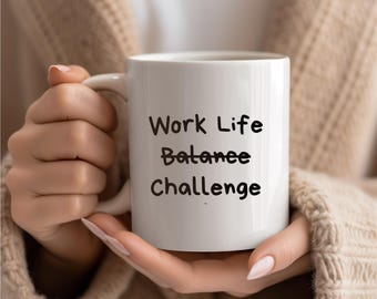 May include: White ceramic mug with black handwritten text that reads "Work Life Balance Challenge".