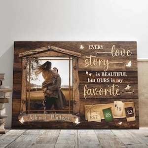 May include: A wooden framed canvas print with a sepia-toned photo of a couple. The print features the text "Every love story is BEAUTIFUL but OURS is my favorite" and the names "Arthur & Madison". Includes the date "05/18/22".