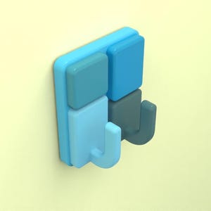May include: A blue and gray wall hook with two hooks. The hook is made of plastic and has a modern design.
