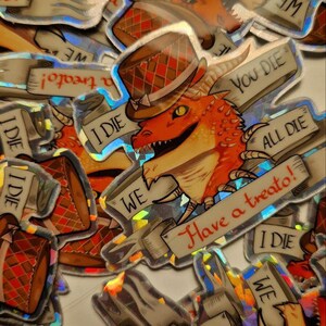 Może przedstawiać: Zbi&oacute;r holograficznych naklejek z kresk&oacute;wkowym smokiem w cylindrze trzymającym znak z napisem "Have a treato!" Naklejki zawierają r&oacute;wnież tekst "You Die", "All Die" i "I Die".