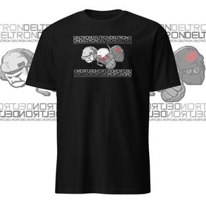 May include: Black t-shirt with a graphic of three robot heads wearing helmets. The text "DELTRONDELTRONDELTRONDE ONDELTRONDELTRONDELTRO" is printed above the robots and the text "ЗОИОЯТВОИОЯТ ЗОИОЯТВО" is printed below the robots.