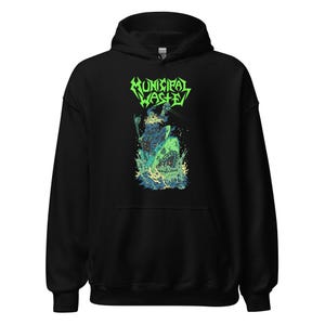 May include: Black hooded sweatshirt with a green and white graphic print of a creature with a skull head and a shark. The text "Municipal Waste" is printed in green above the creature.
