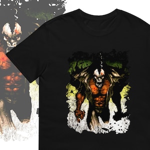 May include: Black t-shirt featuring a graphic print of a red and black monster with a skull face. The monster is standing in a green and yellow grunge background.