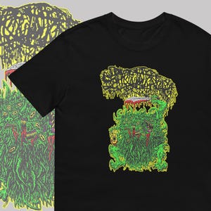May include: Black t-shirt with a green and yellow graphic print of a multi-headed creature with a knife.