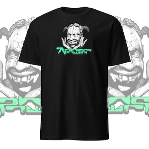 Könnte beinhalten: Schwarzes T-Shirt mit einer grünen Grafik eines Comic-Charakters mit dem Text "Aphex Twin" darunter.