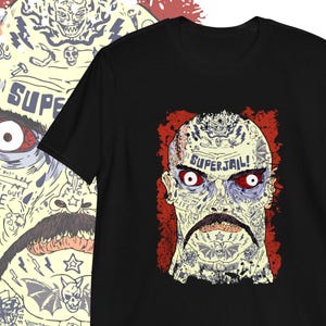 May include: Black t-shirt featuring a graphic of a man's face covered in tattoos. The tattoos include the words "Superjail!" and "Life", "Death", "Born 2 Lose".