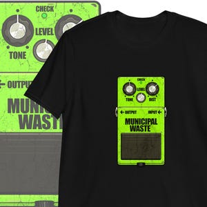 May include: A green and black guitar pedal with the text "MUNICIPAL WASTE" printed on it. The pedal has knobs labeled "CHECK", "LEVEL", "TONE", and "DIST".