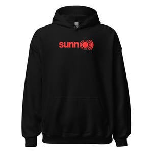 May include: Black hooded sweatshirt with a red logo that says "sunn" with a red circle and concentric circles around it.