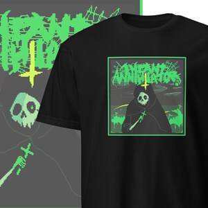 May include: Black t-shirt with a green and black graphic of a hooded figure holding a cross. The graphic is surrounded by a green border and the text "Annihilation" is written in green letters above the figure.