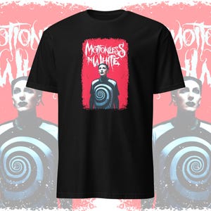 May include: Black t-shirt with a graphic print of a person wearing a white shirt with a spiral design. The graphic also includes the text "Motionless In White" in a white, gothic font.
