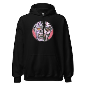 May include: Black hooded sweatshirt with a graphic print of a split face, one side is a cyborg and the other side is a human. The background of the graphic is pink.