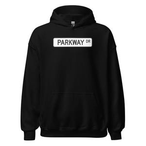 May include: Black hooded sweatshirt with a white street sign that reads "PARKWAY DR" printed on the front.
