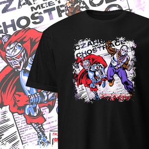 May include: Black t-shirt featuring a comic book style illustration. The graphic shows two figures, one in a red cape and metallic armor, and another in purple pants and a white mask. Text includes "CZARFACE MEETS GHOSTFACE".